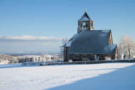 little village with a church in the winterの写真素材