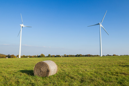 Straw bales in f ront of windmills in Czech Republicの写真素材