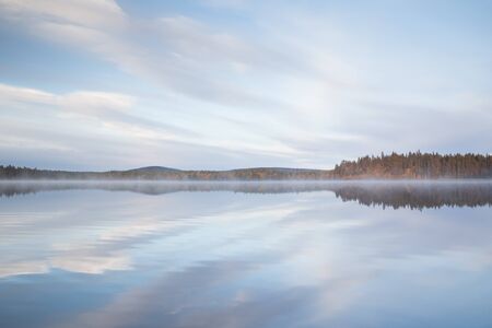 Autumnal lake scenery in Sweden during sunsetの写真素材