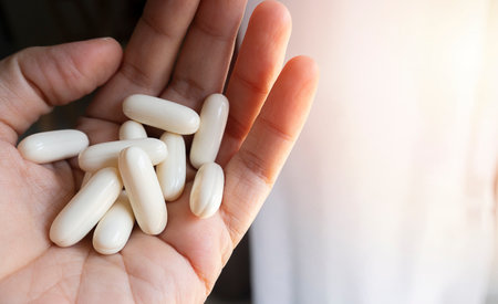 Hand young women holding medicine herbs capsules, female taking supplement product or vitamin type...