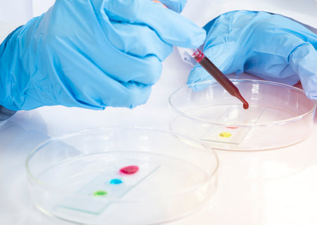 Close up of Scientist hands working with sample at white table in chemical laboratory