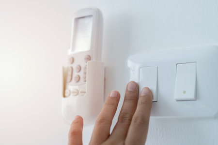 Close up of Female finger is turn off on lighting switch at home. Power, Energy, Saving Electrical, Copy spaceの写真素材