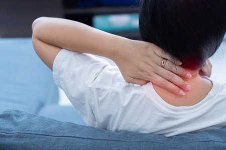 Close-up of Asian woman neck and shoulder pain and injury. Health care and medical concept.の写真素材