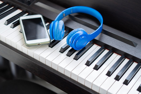Electronic piano with headphones and tablet or phone in studio. Horizontal Composition. Front view.の写真素材