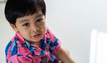Cute Asian child little Thai boy 3 year old looking to camera and smile with happy face concept.の写真素材