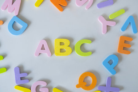 Colorful letters A, B, C and toy building block on  white background. Concept of education, back to...