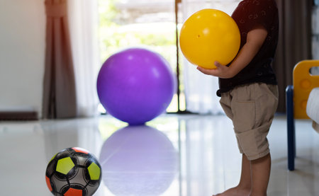 Cropped view of  kid or child playing colorful balls. Activity toys for little kid. Kids and Education Conceptの写真素材