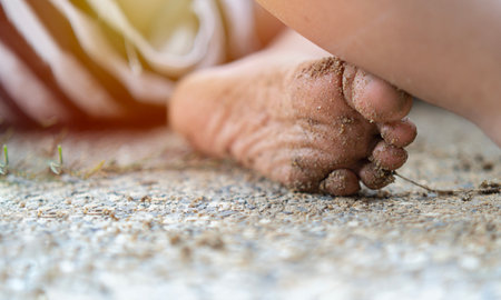 Curious child with dirt or soil on palms after discovering world. Hygiene and children healthcare. Washing hands and foot.の写真素材