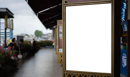 Vertical blank white billboard at passenger port on city street. In the background people and road. Mock up. Poster on street.  Sunny summer day.の写真素材