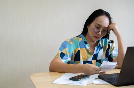 Crop close up of economical woman work on laptop at home pay bills taxes on gadget online, provident female calculate finances expenditures on machine, manage plan family household budget on computerの写真素材
