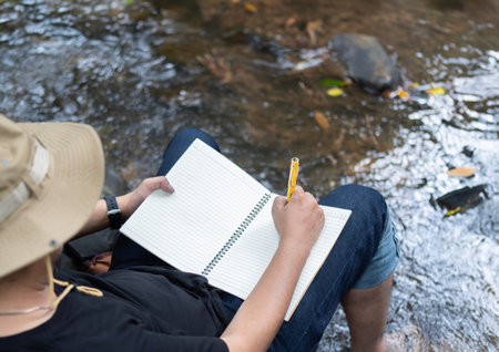 Opened diary in male hands, a man planning his business, thinking and writing his ideas in his...