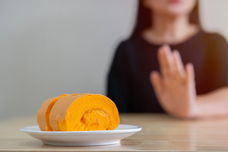 Diet, Dieting asian woman hand in push out, deny sweet, sparkling water, suffering from toothache, sensitivity, inflammation when drink cold. Sensitive teeth, health weight loss peopleの写真素材