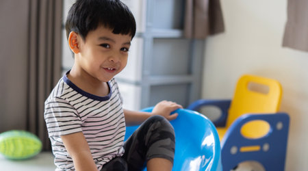 Happy Little asian boy child showing front teeth with big smile and laughing. Healthy happy funny smiling face young adorable lovely male kid.の写真素材