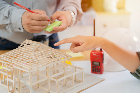 Architect, team and meeting in blueprint planning for construction, architecture or project collaborationの写真素材