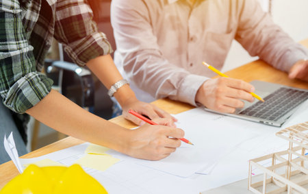 Team of Industrial Engineers Lean on Office Table, Analyze Machinery Blueprints, Architectural Problem Solving, Consult Project on Tablet Computerの写真素材