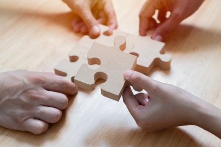Closeup hand of woman connecting jigsaw puzzle with sunlight effect, Business solutions, success and...