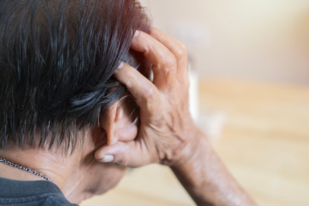 Rear view of elderly patients, Asian senior man patients headache hands on forehead - medical and healthcare concept. Selective focus, copy space.の写真素材