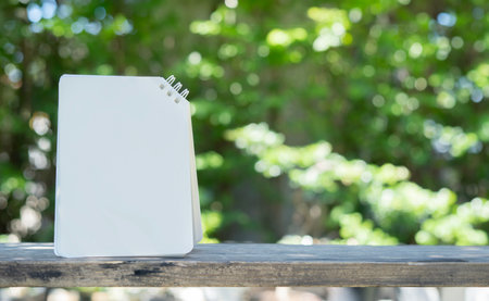 Paper card note set on the wooden table over nature background. Selective focus, copy sapce. Greeting card template.の写真素材