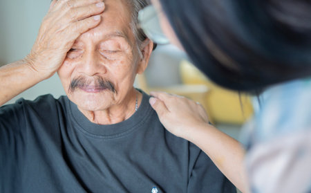 Young Asian woman embrace comfort upset elderly gray-haired dad suffering from depression or problemsの写真素材