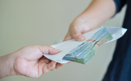 Corruption concept, Business people making a contract with giving a bribery of money.