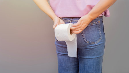 Woman hand holding her bottom and tissue or toilet paper roll. Disorder, Diarrhea, Constipation....
