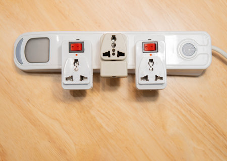 Empty many chargers port on maltiple electrical outlet over wooden background. Concept of electricity consumption.の写真素材