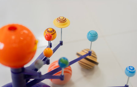 Solar system model toy planets for kid on the floor  with blank space for text. Selective focus, copy space.の写真素材