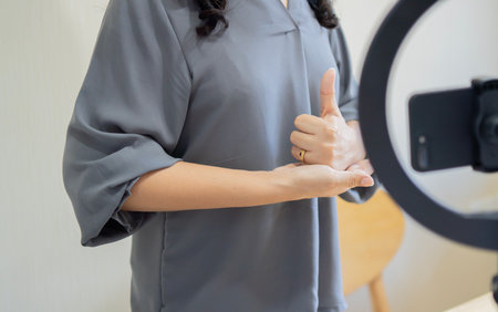 Deaf people blogging concept. Positive caucasian woman talking and showing sign language while...