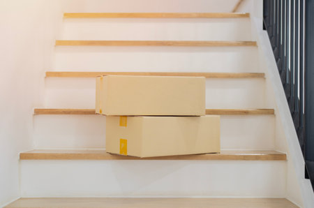 Cardboards and package on steps at home after receiving from the delivery service  from an online order. Online order concept.の写真素材
