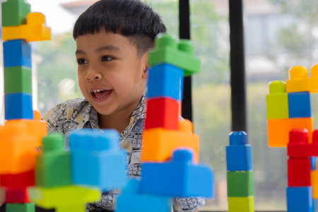Asian child, portrait and little boy with blocks, toys or building for creativity or childhood development on floor at home. Selective focus.の写真素材