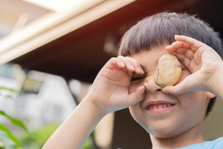 Happy little Asain child boy laughing and playing in the summer day. Copy space. Kids playing concept.の写真素材