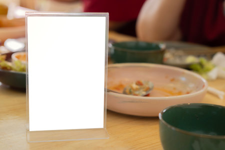 Blank menu sign board, copy space mockup on restaurant table. Copy space, promotion concept.の写真素材
