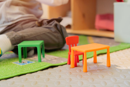 Close-up of child playing toy in classroom, Kindergarten pre school concept. Selective focus.