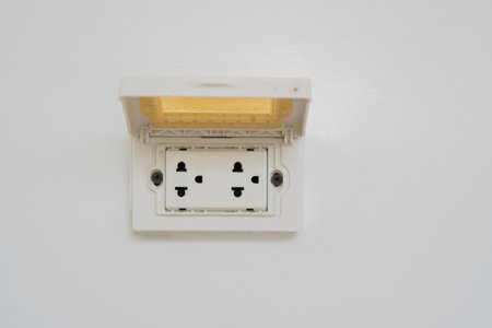 Outdoor electrical outlet with cover on cement wall. A power outlet concept.
