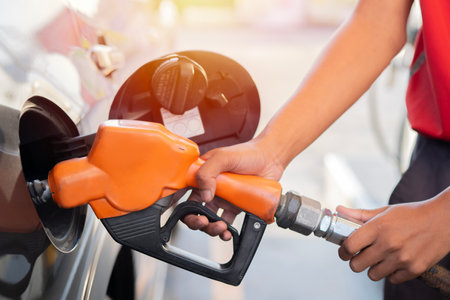 Car refueling on the petrol station. Man refilling the car with fuel. Close up view. Gasoline, diesel is getting more expensive.の写真素材