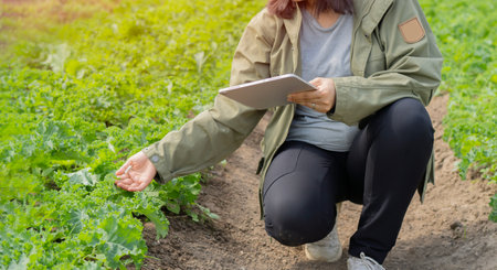 Shot of an unrecognisable woman using a digital tablet while working on a farm. Controlling the plants Concept.の写真素材