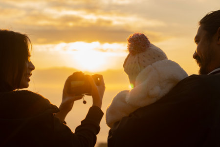 Chiang Mai, Thailand, family with little daughter taking photo on the morning mist at a high mountain.の写真素材