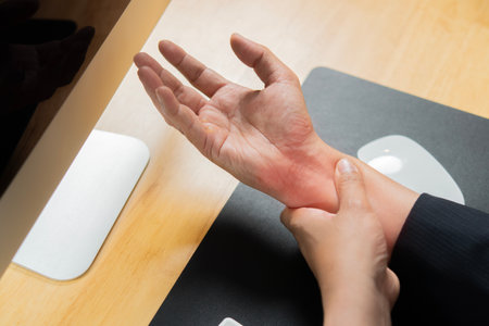 Close up young man right wrist pain , office syndrome , health care concept. Top view.の写真素材