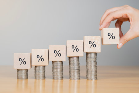 Financial business growth concept. Businessperson calculate income and profit on investments and an increase percentage on pile of coins.の写真素材