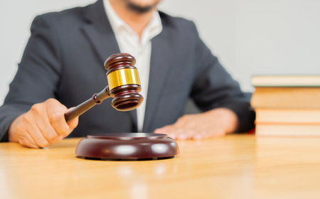 Justice and law concept. Male judge in a courtroom on wooden table. Counselor or Male lawyer working in office. Legal law, advice and justice concept.の写真素材