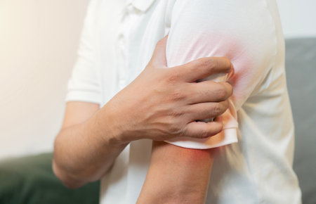 Close-up shot of man experiencing arm pain with highlighted inflammation, symbolizing muscle or joint discomfort.の写真素材