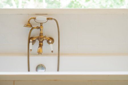 Cropped shot of vintage filtered luxury bathtub near the window decoration in bathroom. Copy space, selective focus.の写真素材