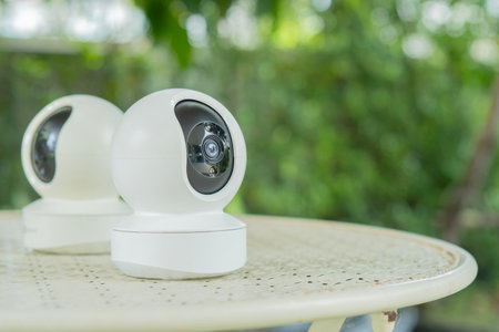 Home smart security camera on garden table. Surveillance tech for remote access video recording....