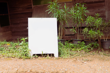White billboard stand sitting in front of the restaurant is decorated in the style of an old wooden house. Blank mockup, copy space.の写真素材