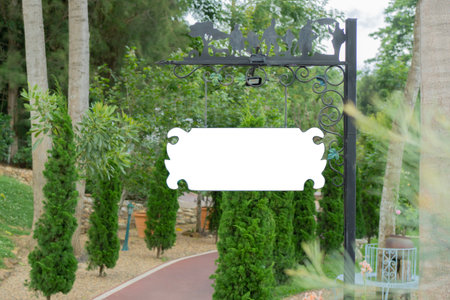 A blank outdoor sign hanging on pole on the side of a road park in an outdoor location. Copy space.の写真素材