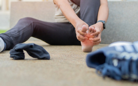 A sportsman runner suffering painful damaged foot, feel ache muscle cramp pain hurt sport trauma workout leg injury at outdoor.の写真素材