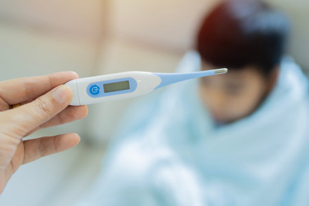 Close-up thermometer.  Mother measuring temperature of her ill kid. Sick child with high fever with...