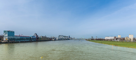 impressive picture from a bridge zo the cologne skyline with the old an new buildingの写真素材