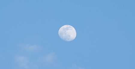 The full moon in the sky during the day.の写真素材