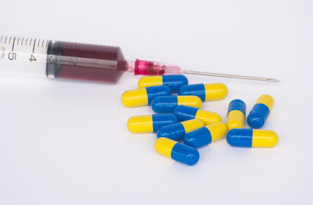 Syringes, capsules and tablets. On a white background. blur.